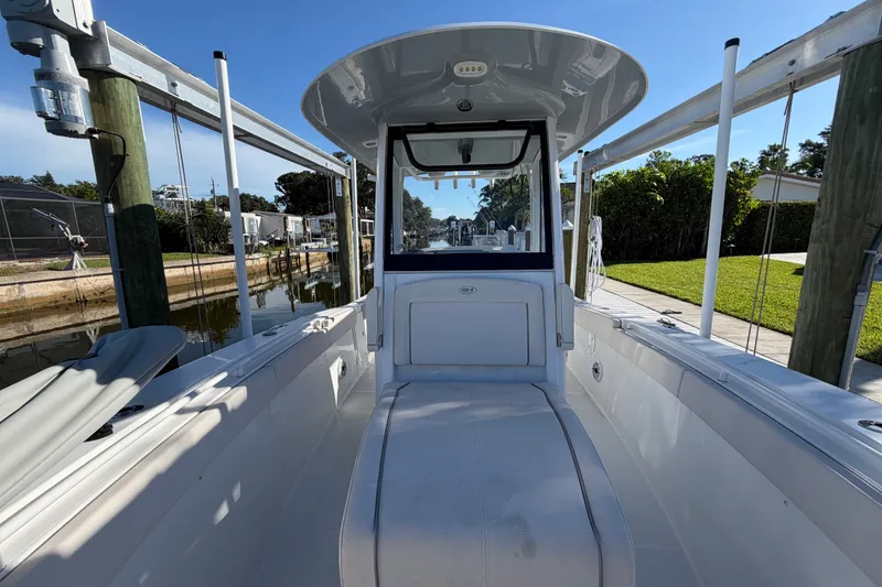 Slide: The Image of 2025 Sea Hunt Gamefish 27CB boat docked, showcasing spacious interior and sleek design. - 53