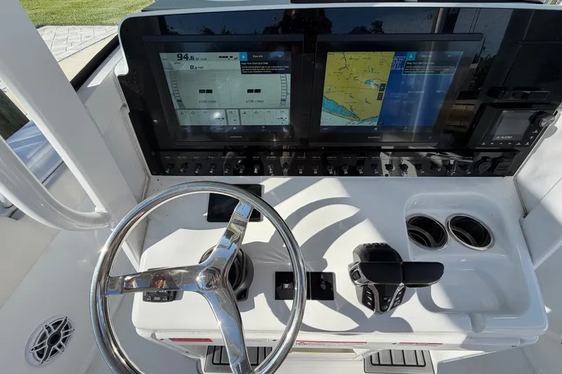 Slide: The Image of Helm of 2025 Sea Hunt Gamefish 27CB with dual Garmin displays and controls. - 30