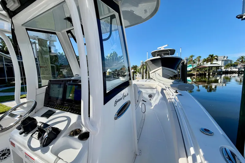 Slide: The Image of 2025 Sea Hunt Gamefish 27CB boat docked, featuring modern controls and sleek design. - 37