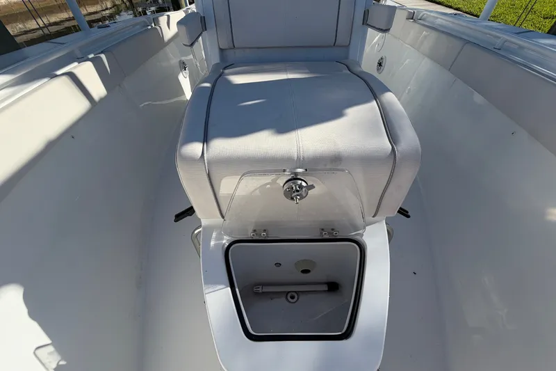 Slide: The Image of 2025 Sea Hunt Gamefish 27CB boat interior with storage compartment open. - 49