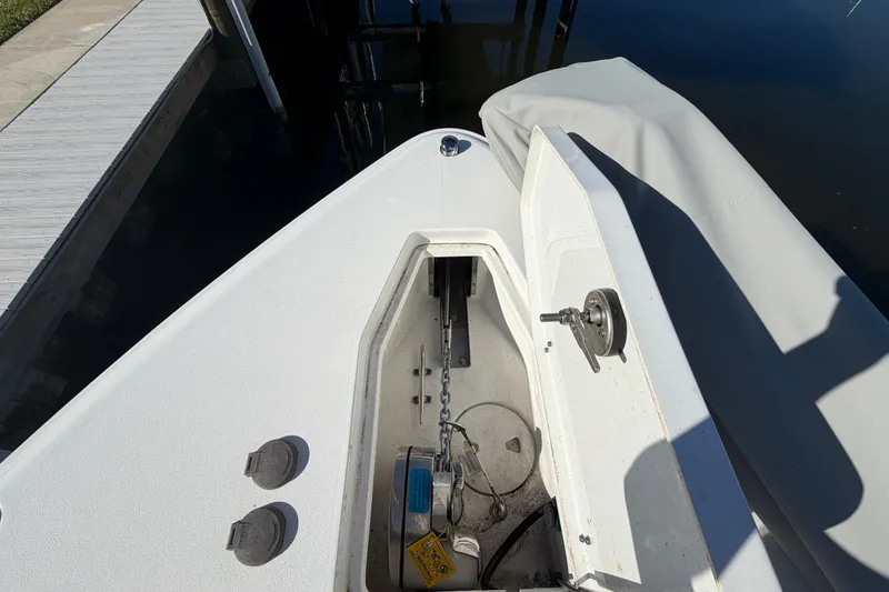 Slide: The Image of 2025 Sea Hunt Gamefish 27CB anchor compartment, open lid, dockside view. - 47