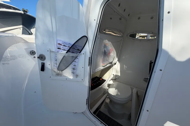 Slide: The Image of Interior view of 2025 Sea Hunt Gamefish 27CB boat's compact bathroom. - 39