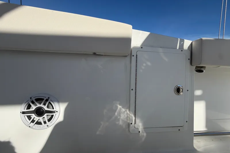 Slide: The Image of 2025 Sea Hunt Gamefish 27CB boat interior with speaker and storage compartment. - 65
