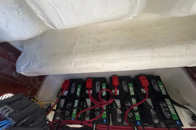 Slide: The Image of Battery compartment of 2025 Sea Hunt Gamefish 27CB with multiple batteries and wiring. - 44