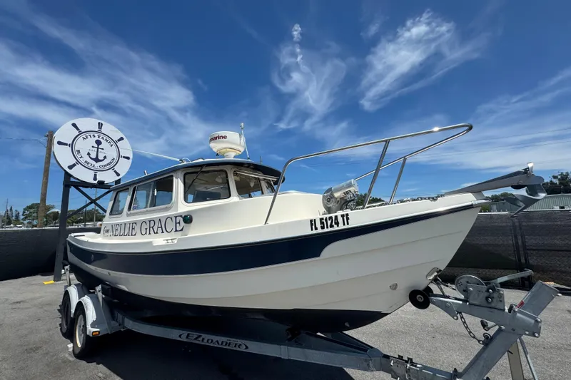 Slide: The Image of 2013 C-Dory 22' Cruiser boat on trailer under clear blue sky. - 0