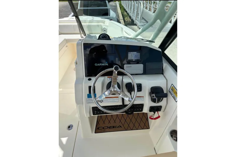 Slide: The Image of 2021 Cobia 240 Dual Console boat helm with Garmin navigation system. - 14