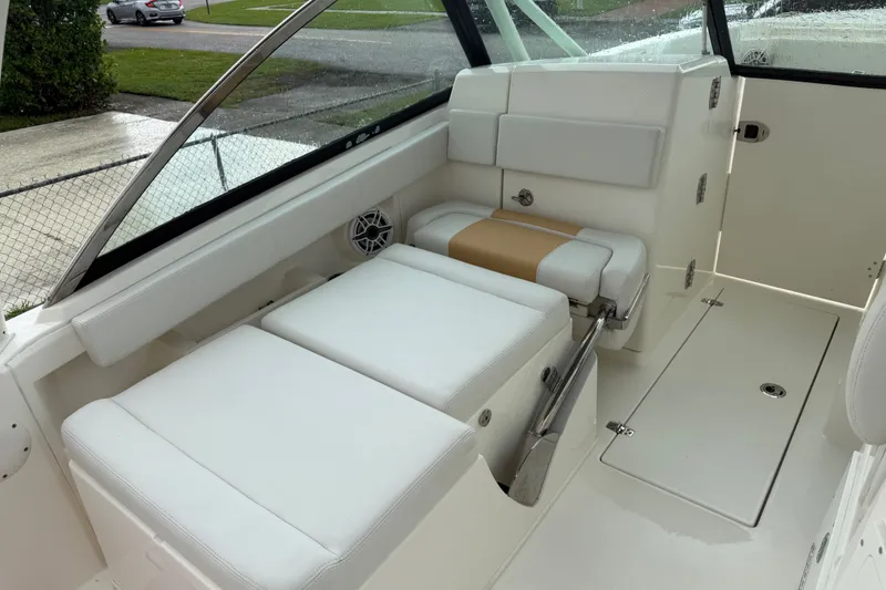 Slide: The Image of 2021 Cobia 240 Dual Console interior with white seating and sleek design. - 33
