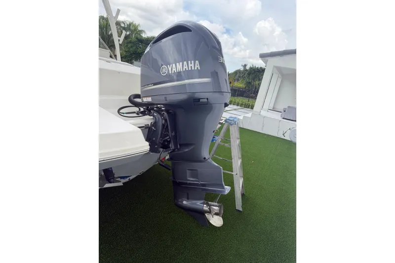 Slide: The Image of Yamaha outboard motor on 2021 Cobia 240 Dual Console boat, parked on grass. - 19