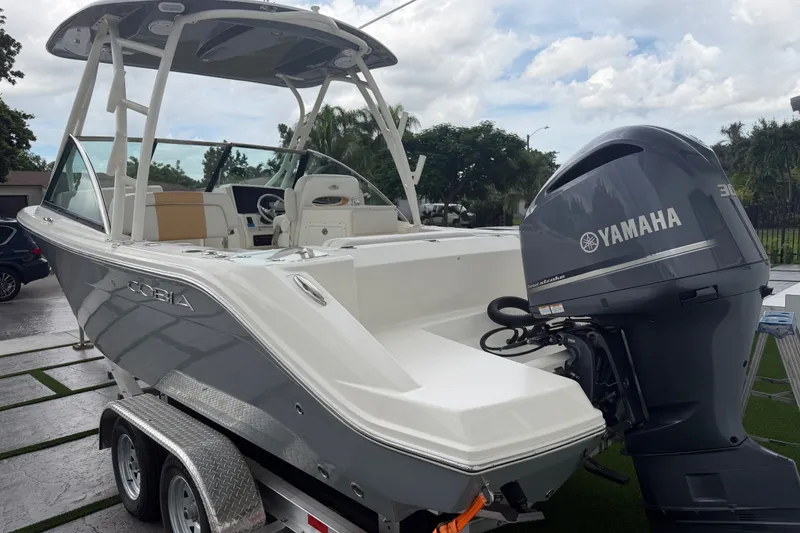 Slide: The Image of 2021 Cobia 240 Dual Console boat with Yamaha engine on trailer. - 18