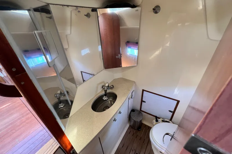 Slide: The Image of 2013 Gemini Legacy 35 yacht bathroom with sink, mirror, and toilet. - 118