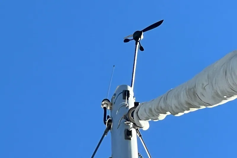 Slide: The Image of Mast of Gemini Legacy 35 sailboat with wind vane against clear blue sky. - 160