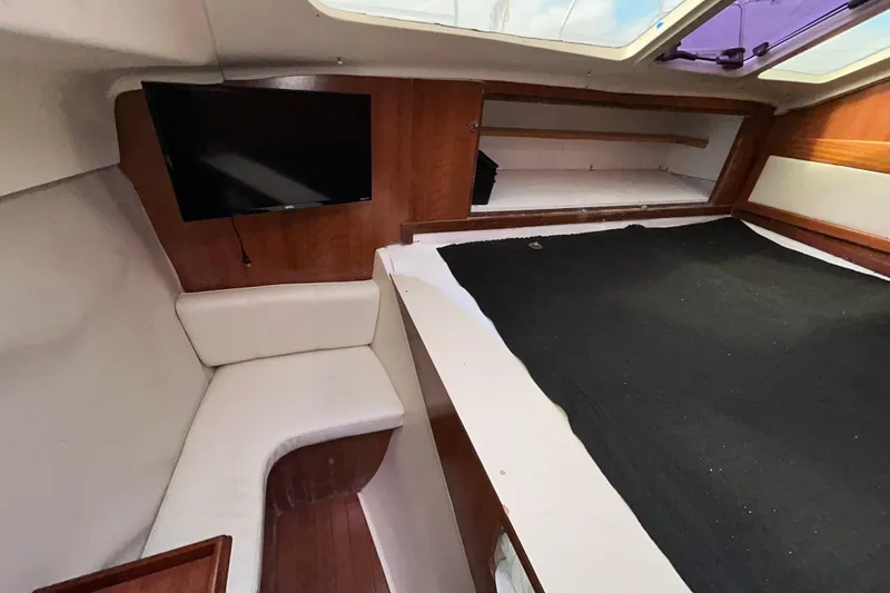 Slide: The Image of Interior of 2013 Gemini Legacy 35 sailboat with seating, bed, and mounted TV. - 126