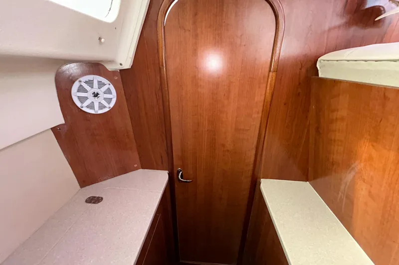Slide: The Image of Interior of 2013 Gemini Legacy 35 boat with wood paneling and speaker. - 123