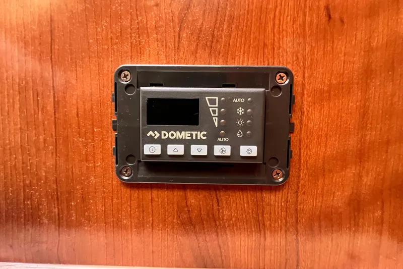 Slide: The Image of Dometic control panel on Gemini Legacy 35, 2013 model, mounted on wooden surface. - 134