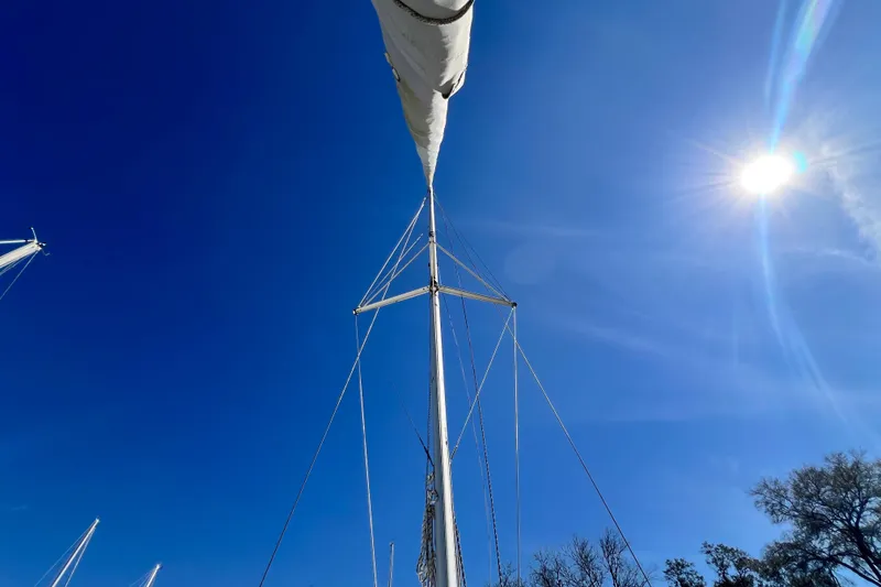 Slide: The Image of Sailboat mast of 2013 Gemini Legacy 35 under clear blue sky and bright sun. - 157