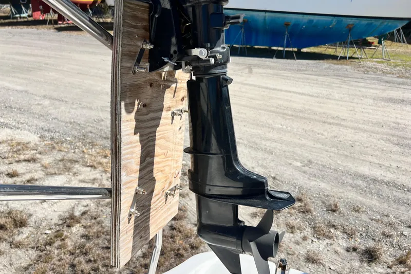 Slide: The Image of Outboard motor mounted on a Gemini Legacy 35 sailboat, 2013 model, in a boatyard. - 83