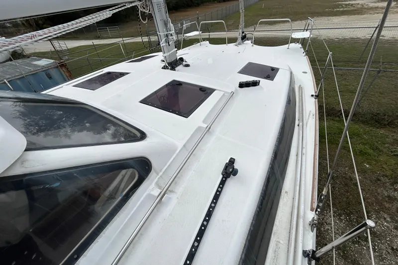 Slide: The Image of 2013 Gemini Legacy 35 sailboat deck with hatches and railing, docked outdoors. - 29