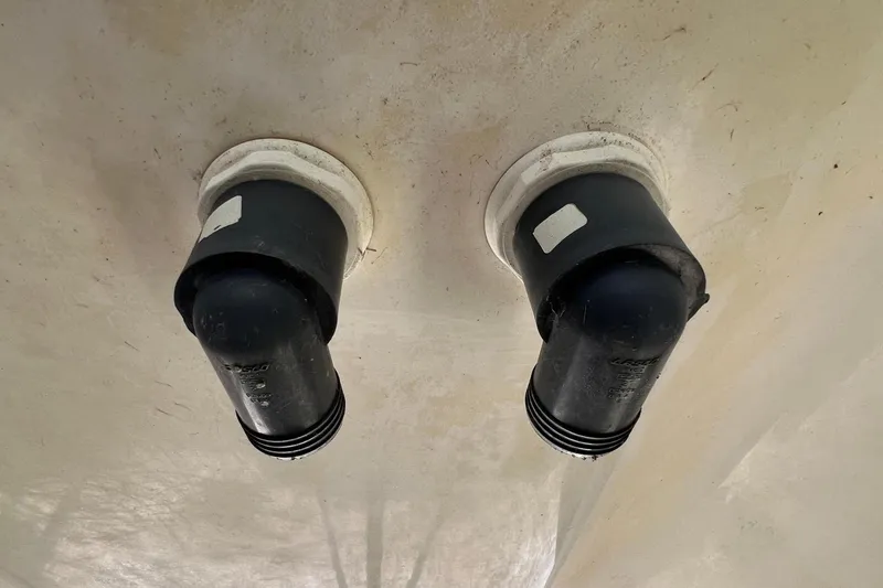 Slide: The Image of Two black exhaust ports on Gemini Legacy 35 boat hull, 2013 model. - 150