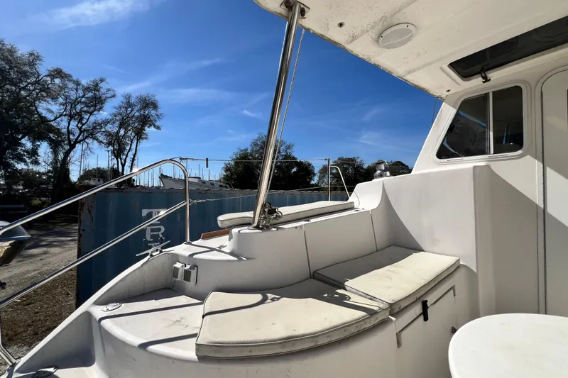 Slide: The Image of 2013 Gemini Legacy 35 boat deck with seating, under clear blue sky. - 72