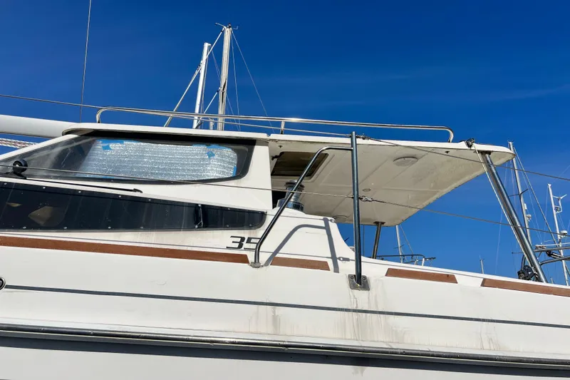 Slide: The Image of 2013 Gemini Legacy 35 sailboat with sleek design against clear blue sky. - 13