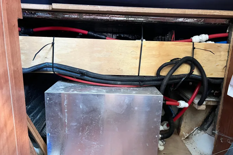 Slide: The Image of Engine compartment of a 2013 Gemini Legacy 35 sailboat with visible wiring and components. - 99