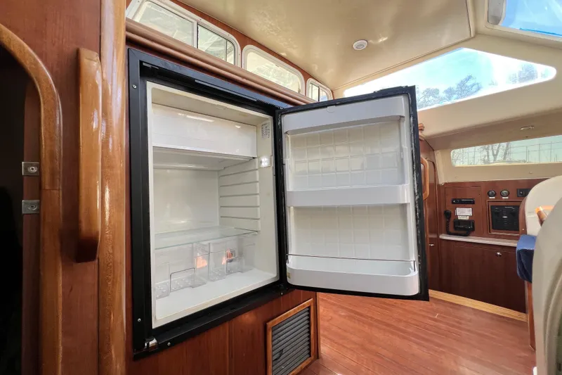 Slide: The Image of Open refrigerator inside 2013 Gemini Legacy 35 yacht with wooden interior. - 113