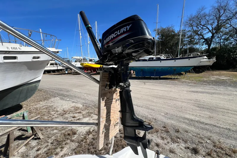 Slide: The Image of Outboard motor on Gemini Legacy 35 sailboat, 2013 model, in a boatyard setting. - 80