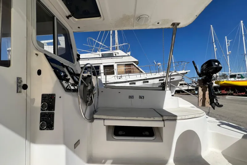Slide: The Image of Cockpit view of 2013 Gemini Legacy 35 sailboat with steering wheel and controls. - 67