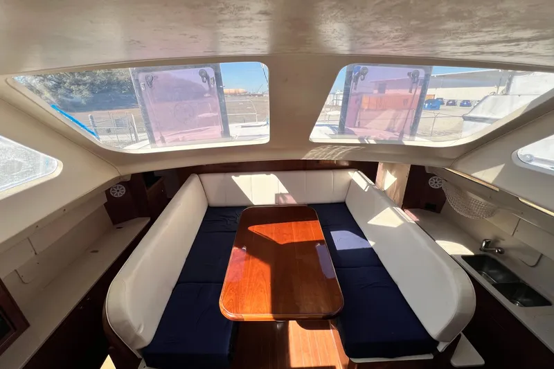 Slide: The Image of Interior of 2013 Gemini Legacy 35 catamaran with spacious seating and wooden table. - 85