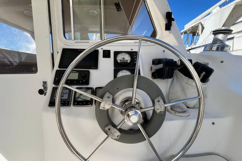 Slide: The Image of Steering wheel and controls of 2013 Gemini Legacy 35 sailboat cockpit. - 69