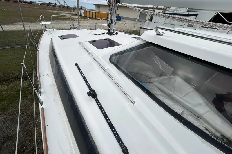Slide: The Image of 2013 Gemini Legacy 35 sailboat deck with hatches and rigging, docked in a marina. - 32