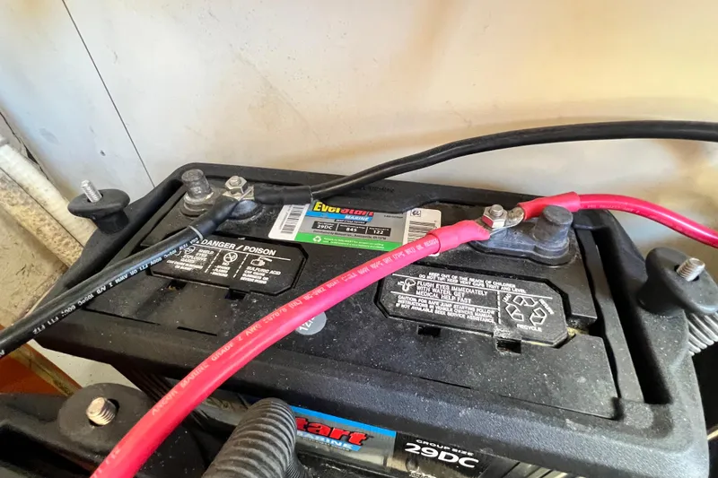 Slide: The Image of Close-up of a 2013 Gemini Legacy 35 battery with red and black cables connected. - 143