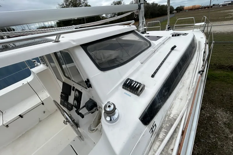 Slide: The Image of 2013 Gemini Legacy 35 sailboat cockpit and deck, featuring steering wheel and control panels. - 28