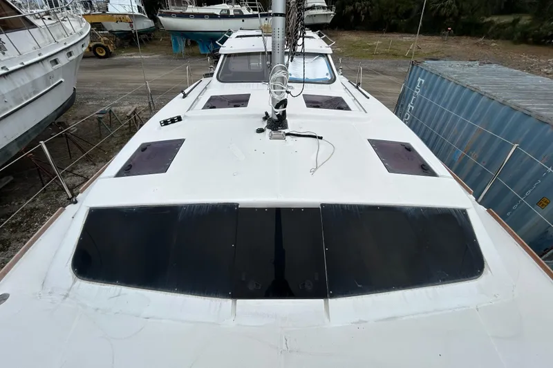 Slide: The Image of 2013 Gemini Legacy 35 catamaran on land, showcasing deck and hatches. - 52