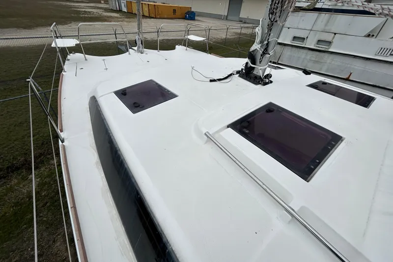 Slide: The Image of 2013 Gemini Legacy 35 sailboat deck with hatches and rigging, docked in a yard. - 33