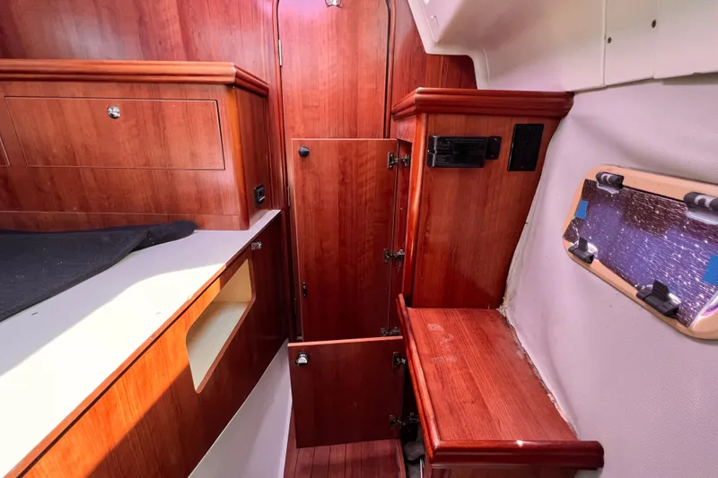 Slide: The Image of Interior of 2013 Gemini Legacy 35 sailboat with wooden cabinetry and window. - 136
