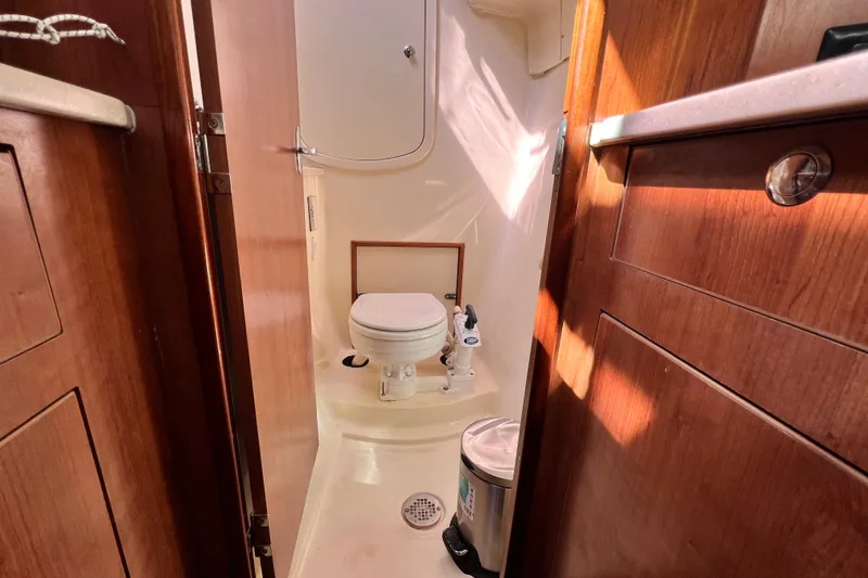 Slide: The Image of Compact bathroom in 2013 Gemini Legacy 35 boat with wooden cabinetry and marine toilet. - 107