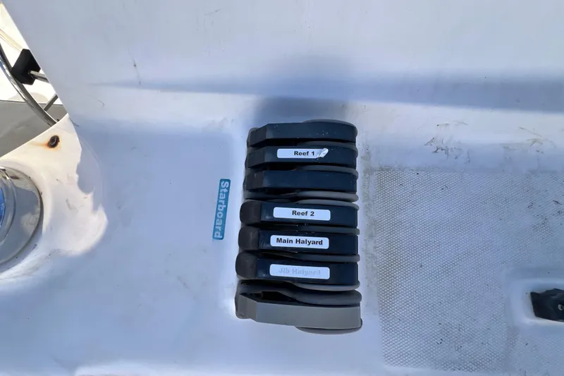 Slide: The Image of Sailing controls on a 2013 Gemini Legacy 35, labeled for reefing and halyards. - 165