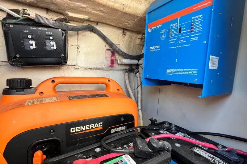 Slide: The Image of Electrical setup in a 2013 Gemini Legacy 35, featuring a Generac generator and Victron Energy inverter. - 141