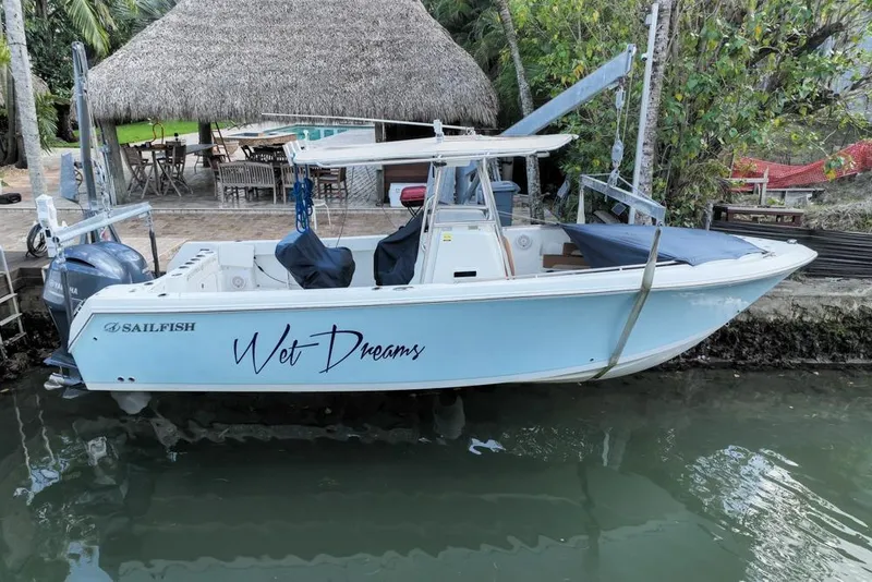Slide: The Image of 2005 Sailfish 2660 CC boat docked by a tropical hut. - 4