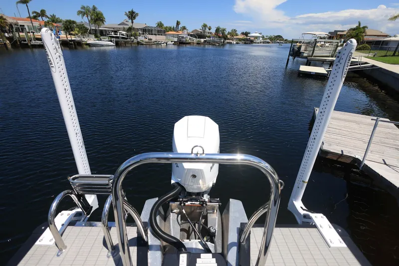 Slide: The Image of 2025 Tahoe Pontoon LTZ 23 on a serene waterfront dock, showcasing its sleek design. - 20