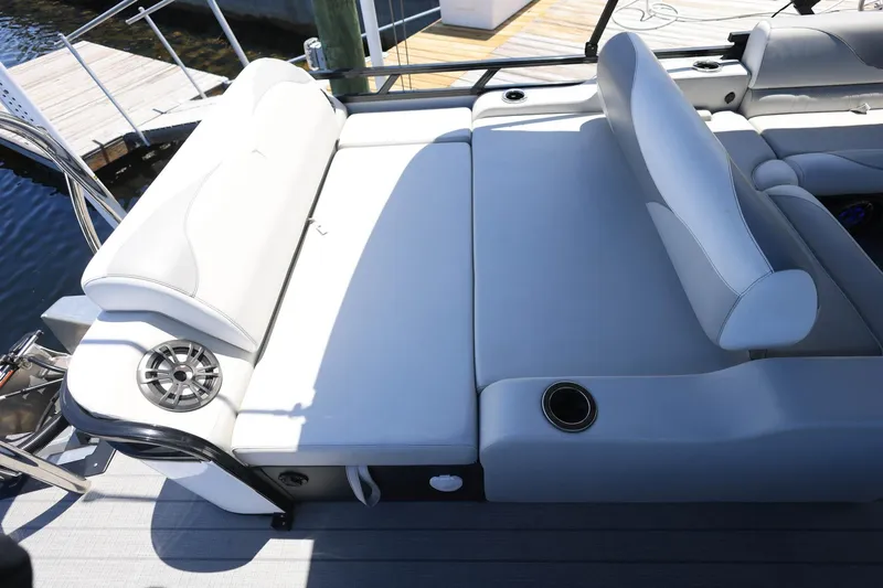 Slide: The Image of 2025 Tahoe Pontoon LTZ 23 boat interior with luxurious seating and cup holders. - 18