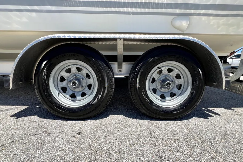 Slide: The Image of Trailer wheels of a 2013 Novurania Chase 23 boat on pavement. - 15