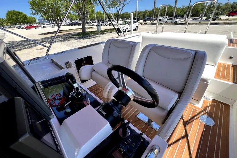 Slide: The Image of 2013 Novurania Chase 23 boat interior with steering wheel and seating. - 51