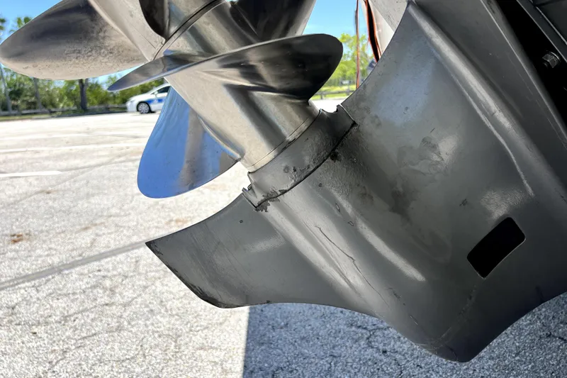 Slide: The Image of Close-up of a 2013 Novurania Chase 23 boat propeller in a parking lot. - 8