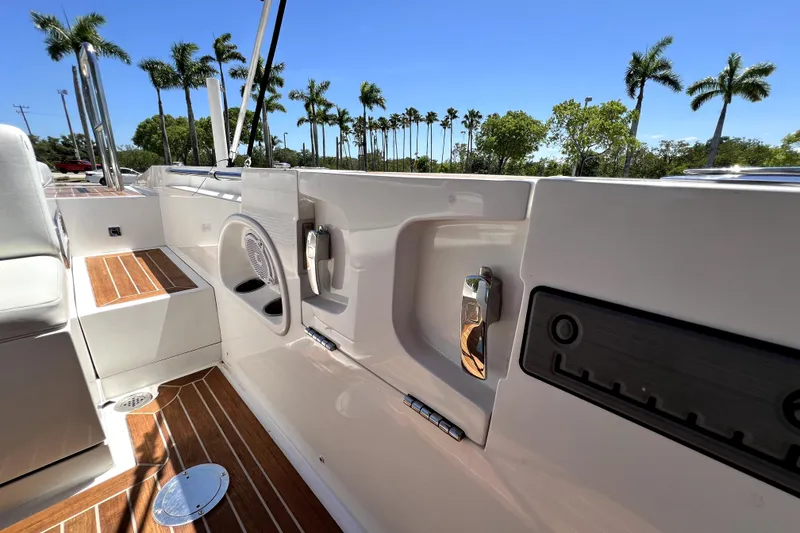 Slide: The Image of 2013 Novurania Chase 23 boat interior with teak flooring and palm trees in background. - 75