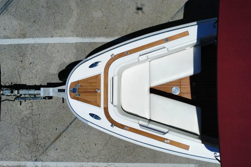 Slide: The Image of Overhead view of 2013 Novurania Chase 23 boat on trailer, featuring white seating and wood accents. - 27