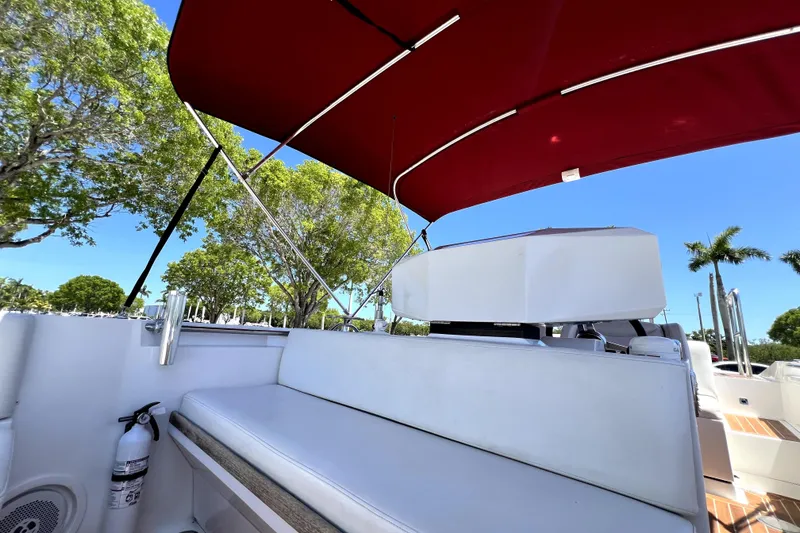 Slide: The Image of 2013 Novurania Chase 23 boat with red canopy and white seating. - 38
