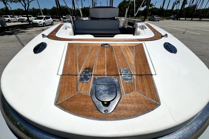 Slide: The Image of 2013 Novurania Chase 23 boat with wooden deck detail in a parking lot. - 22