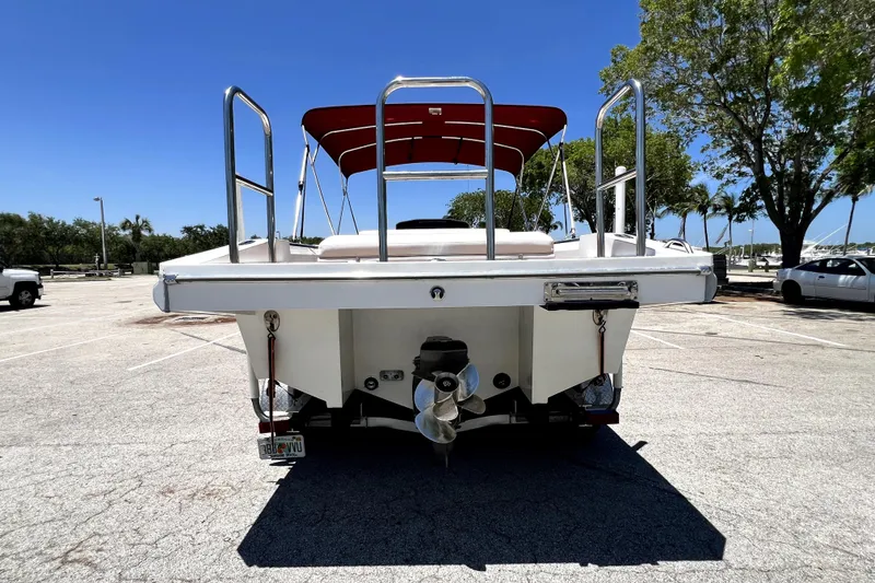 Slide: The Image of 2013 Novurania Chase 23 boat with red canopy in parking lot. - 5